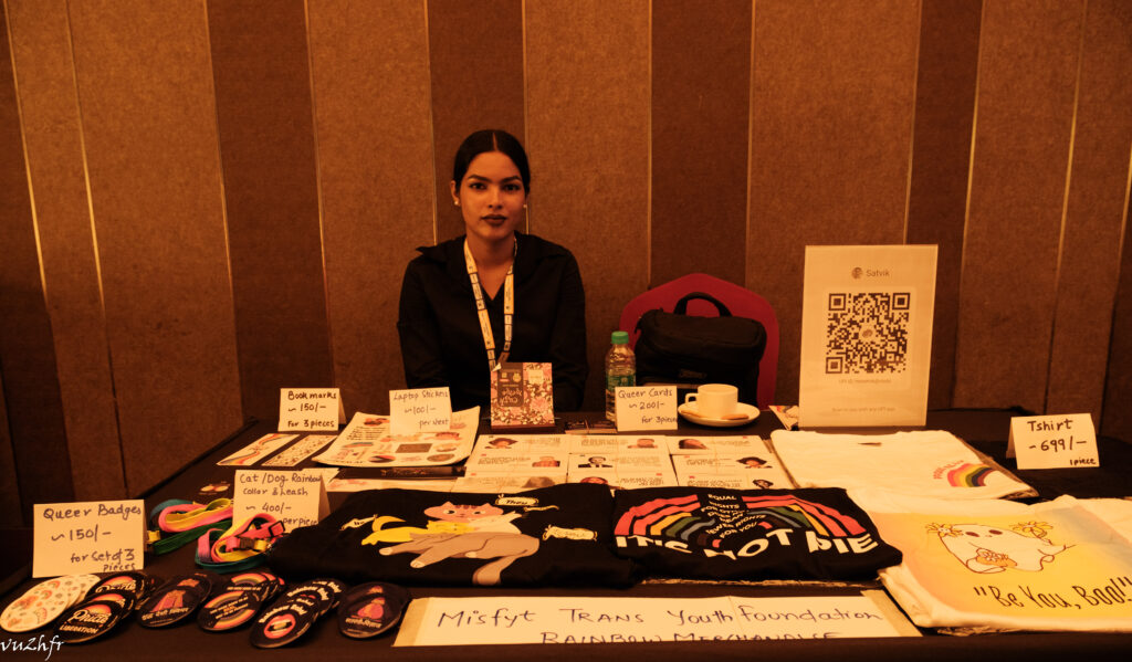 A trans entrepreneur with their merchandise