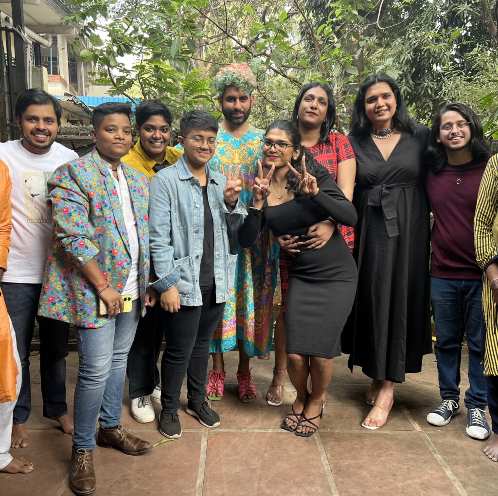 Alok Menon in India visiting shelter home with trans people standing in a group looking vibrant